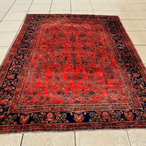 Handmade Antique Persian Sarouk Carpet in rich brick red and navy border viewed from the deep pile side, 10 feet 11 inches by 8 feet 5 inches