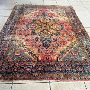 Handmade Antique Persian Sarouk Medallion Carpet in muted terracotta, navy, slate blue and warm gold, 11 feet 5 inches by 8 feet 8 inches