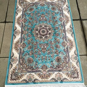 New Persian hand-finished Silk Qum carpet, 5' x 3'3", with a luminous turquoise field, ivory border and intricate central medallion at The Chapman Collection